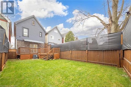 View of yard featuring a wooden deck and cooling unit - 45 Munroe Street, Hamilton, ON - Outdoor With Deck Patio Veranda