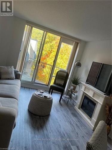 504 - 8111 Forest Glen Drive, Niagara Falls (208 - Mt. Carmel), ON - Indoor Photo Showing Living Room With Fireplace