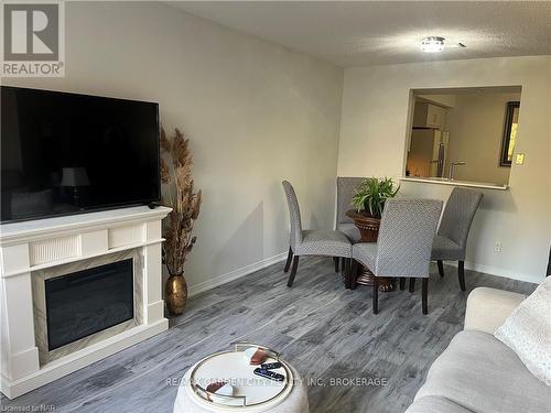 504 - 8111 Forest Glen Drive, Niagara Falls (208 - Mt. Carmel), ON - Indoor Photo Showing Living Room With Fireplace