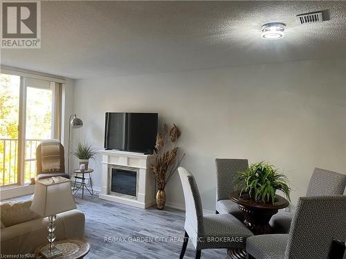 504 - 8111 Forest Glen Drive, Niagara Falls (208 - Mt. Carmel), ON - Indoor Photo Showing Living Room With Fireplace