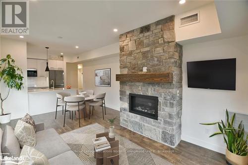 207 - 11 Beckwith Lane, Blue Mountains (Blue Mountain Resort Area), ON - Indoor Photo Showing Living Room With Fireplace