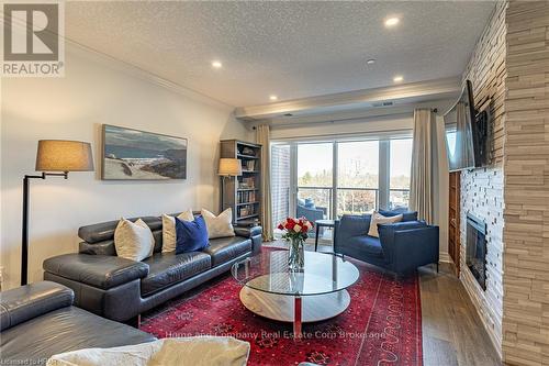 405 - 235 John Street N, Stratford, ON - Indoor Photo Showing Living Room With Fireplace