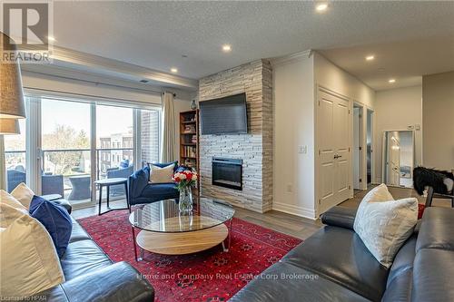 405 - 235 John Street N, Stratford, ON - Indoor Photo Showing Living Room With Fireplace