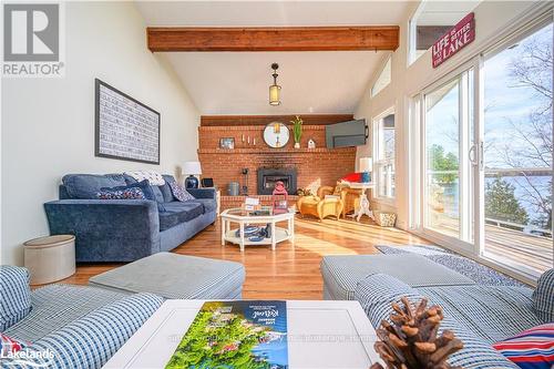 562 & 568 Waseosa Lake Road, Huntsville (Chaffey), ON - Indoor Photo Showing Living Room With Fireplace