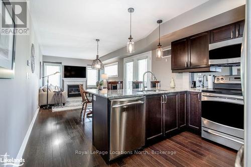 308 - 4 Brandy Lane Drive, Collingwood, ON - Indoor Photo Showing Kitchen With Fireplace With Stainless Steel Kitchen With Upgraded Kitchen