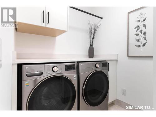 Front Loading Washer and Dryer - 9201 Okanagan Centre Road W Unit# 5, Lake Country, BC - Indoor Photo Showing Laundry Room