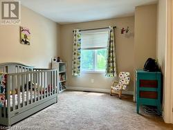 Carpeted bedroom featuring a crib - 