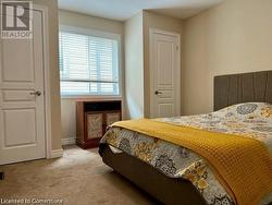 Bedroom featuring light colored carpet - 