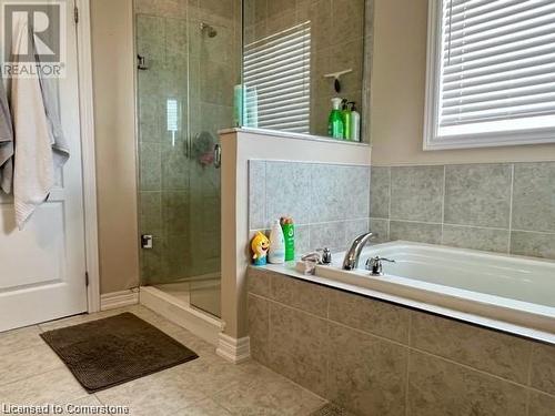 Bathroom featuring separate shower and tub and tile patterned flooring - 683 Robert Ferrie Drive, Kitchener, ON - Indoor Photo Showing Bathroom