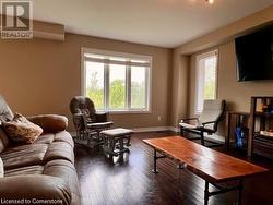 Sitting room featuring dark wood-type flooring - 