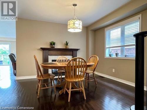 Dining room featuring dark wood-type flooring and a healthy amount of sunlight - 683 Robert Ferrie Drive, Kitchener, ON - Indoor Photo Showing Dining Room