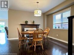 Dining room featuring dark wood-type flooring and a healthy amount of sunlight - 