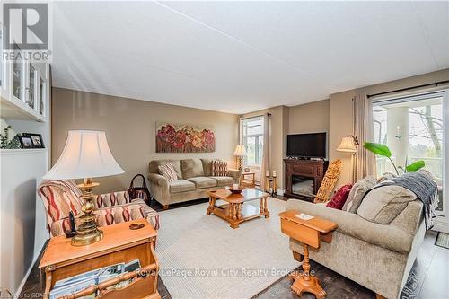 401 - 8 Christopher Court, Guelph (Hanlon Creek), ON - Indoor Photo Showing Living Room With Fireplace