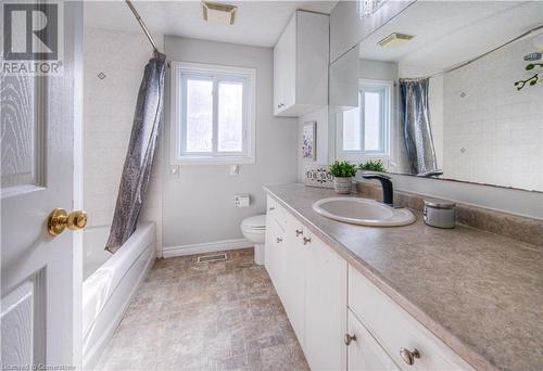 Full bathroom featuring vanity, shower / bath combination with curtain, and toilet - 83 Bridlewreath Street, Kitchener, ON - Indoor Photo Showing Bathroom