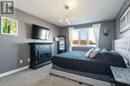 36 Ahrens Drive, Stratford (Downie), ON - Indoor Photo Showing Bedroom With Fireplace