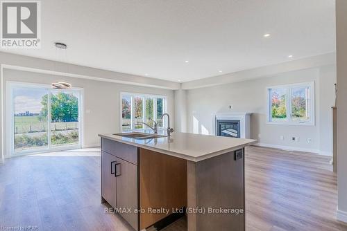 139 Mill Race Crescent, Woolwich, ON - Indoor Photo Showing Kitchen With Fireplace With Double Sink