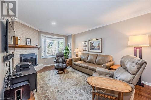 106 - 121 Waterloo Avenue, Guelph (Central West), ON - Indoor Photo Showing Living Room With Fireplace