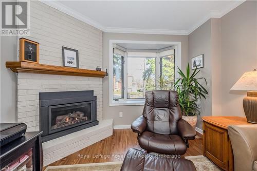 106 - 121 Waterloo Avenue, Guelph (Central West), ON - Indoor Photo Showing Living Room With Fireplace