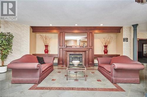 427 - 8111 Forest Glen Drive, Niagara Falls (208 - Mt. Carmel), ON - Indoor Photo Showing Living Room With Fireplace