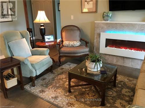 127 - 8111 Forest Glen Drive, Niagara Falls (208 - Mt. Carmel), ON - Indoor Photo Showing Living Room With Fireplace