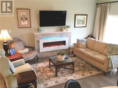 127 - 8111 Forest Glen Drive, Niagara Falls (208 - Mt. Carmel), ON - Indoor Photo Showing Living Room With Fireplace