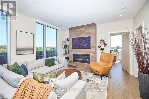 604 - 57 Lakeport Road, St. Catharines (438 - Port Dalhousie), ON - Indoor Photo Showing Living Room With Fireplace