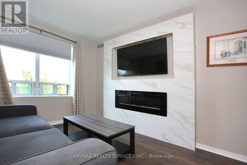 215 - 55 Via Rosedale Avenue, Brampton, ON - Indoor Photo Showing Living Room With Fireplace