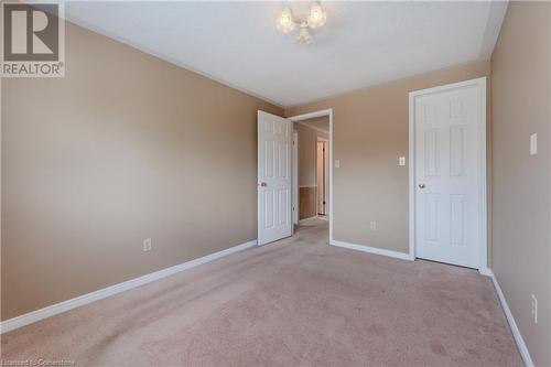 Empty room featuring light colored carpet - 10 Fenwick Court, Kitchener, ON 