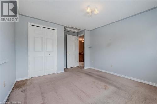 Unfurnished bedroom with light colored carpet and a closet - 10 Fenwick Court, Kitchener, ON 