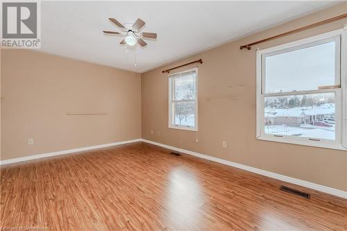 Unfurnished room featuring ceiling fan and light hardwood / wood-style floors - 10 Fenwick Court, Kitchener, ON 