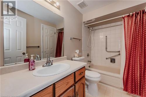 Full bathroom featuring tile patterned floors, vanity, shower / tub combo, and toilet - 10 Fenwick Court, Kitchener, ON 