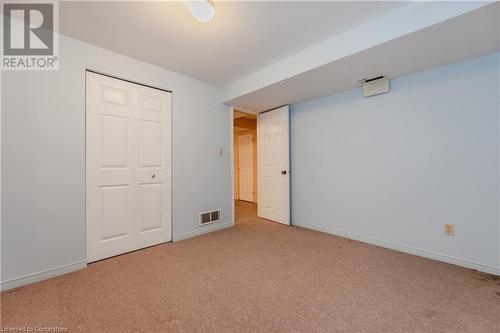 Unfurnished bedroom featuring light colored carpet and a closet - 10 Fenwick Court, Kitchener, ON 