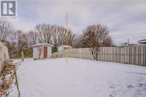 Snowy yard featuring a storage shed - 10 Fenwick Court, Kitchener, ON 