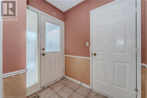 Doorway to outside with light tile patterned floors - 10 Fenwick Court, Kitchener, ON 