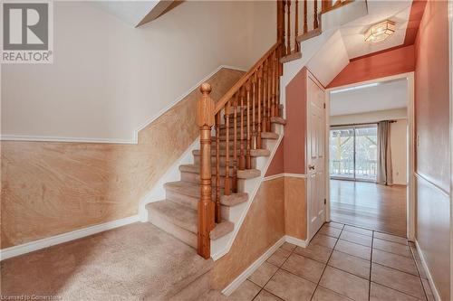 Staircase featuring a towering ceiling and tile patterned floors - 10 Fenwick Court, Kitchener, ON 