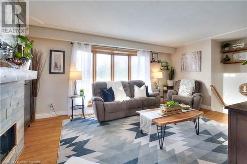 Living room featuring light wood-type flooring and a tile fireplace - 19 Halifax Drive, Kitchener, ON - Indoor Photo Showing Living Room With Fireplace