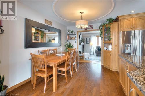 Dining room featuring a tray ceiling, a notable chandelier, and hardwood / wood-style flooring - 19 Halifax Drive, Kitchener, ON - Indoor Photo Showing Dining Room