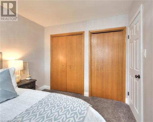 Bedroom with dark colored carpet and multiple closets - 19 Halifax Drive, Kitchener, ON - Indoor Photo Showing Bedroom