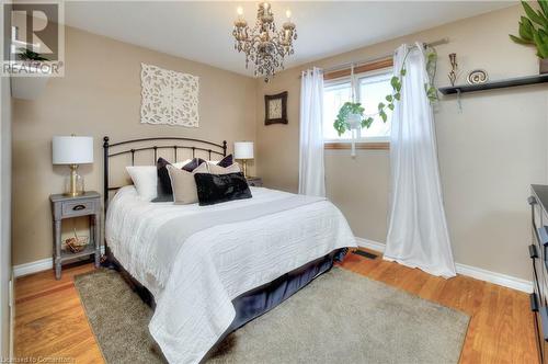 Bedroom featuring hardwood / wood-style floors and an inviting chandelier - 19 Halifax Drive, Kitchener, ON - Indoor Photo Showing Bedroom