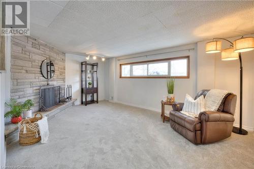 Sitting room with light carpet and a fireplace - 19 Halifax Drive, Kitchener, ON - Indoor With Fireplace