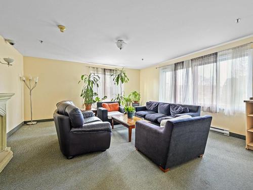 Salle communautaire - 207-445 Av. Ste-Croix, Montréal (Saint-Laurent), QC - Indoor Photo Showing Living Room With Fireplace