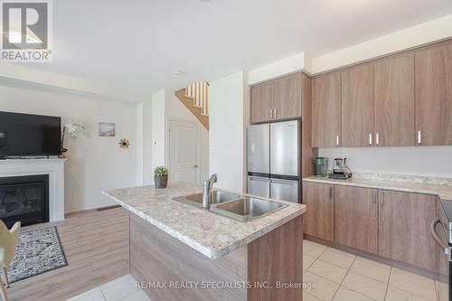 23 Povey Road, Centre Wellington, ON - Indoor Photo Showing Kitchen With Fireplace With Double Sink