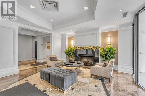 102 - 16 Dallimore Circle, Toronto, ON - Indoor Photo Showing Living Room With Fireplace