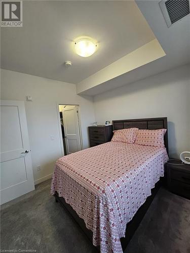 View of carpeted bedroom - 251 Northfield Drive E Unit# 401, Waterloo, ON - Indoor Photo Showing Bedroom