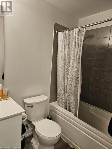 Full bathroom with vanity, toilet, wood-type flooring, and shower / tub combo with curtain - 251 Northfield Drive E Unit# 401, Waterloo, ON - Indoor Photo Showing Bathroom