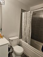 Full bathroom with vanity, toilet, wood-type flooring, and shower / tub combo with curtain - 