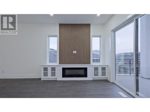 Living room w/electric fireplace - 2798 Canyon Crest Drive, West Kelowna, BC - Indoor With Fireplace