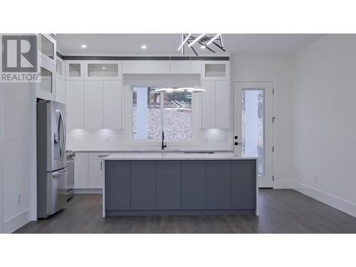 Oversized kitchen island with walk in pantry, high end SS appliances and gorgeous views of the surrounding forest - 2798 Canyon Crest Drive, West Kelowna, BC - Indoor Photo Showing Kitchen With Upgraded Kitchen