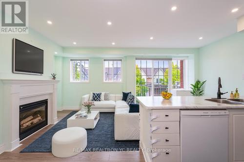 B202 - 98 Cornell Park Avenue, Markham, ON - Indoor Photo Showing Living Room With Fireplace