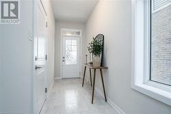 Doorway featuring light tile patterned floors - 